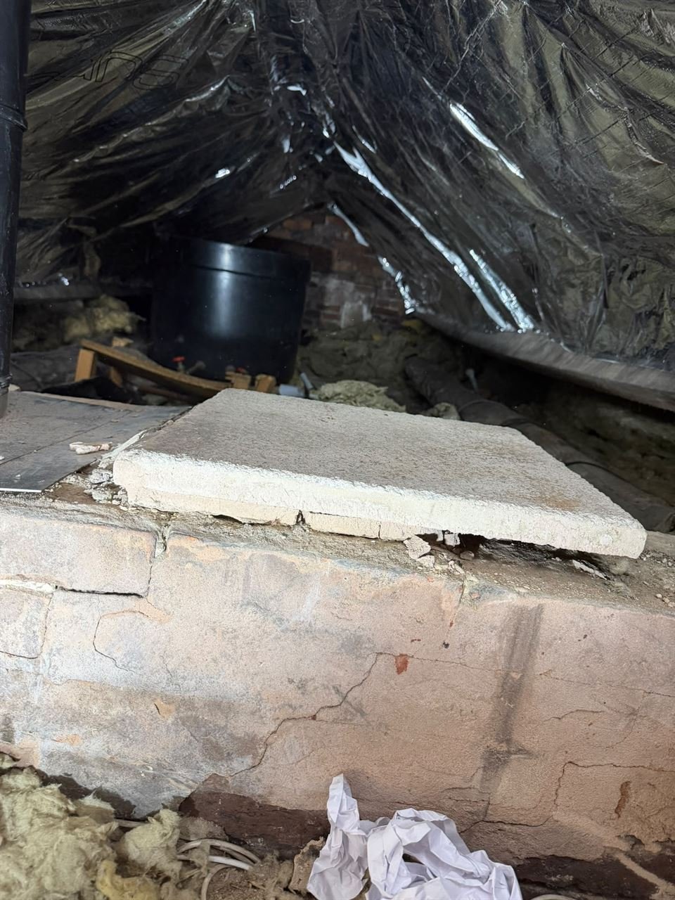 SuperFOIL insulation lining the roof above a brick chimney breast in a loft